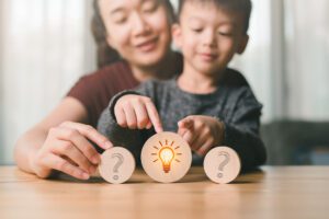 A child picking idea button along with her parent in order to sustain motivation.